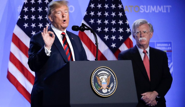 U.S. President Donald Trump, left, is flanked by national security adviser John Bolton, right during a press conference after a summit of heads of state and government at NATO headquarters in Brussels, Belgium, Thursday, July 12, 2018 