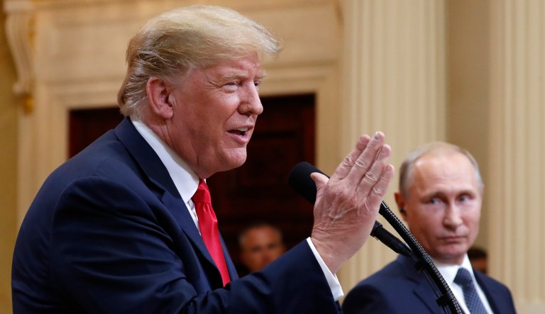 U.S. President Donald Trump speaks with Russian President Vladimir Putin during a press conference after their meeting at the Presidential Palace in Helsinki, Finland, Monday, July 16, 2018.