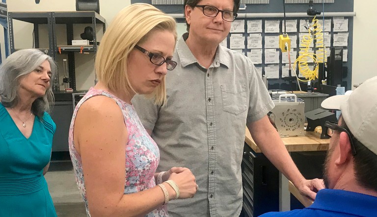 Rep. Krysten Sinema visits Blockwise Engineering in Tempe, Ariz., on July 2, 2018, and speaks with company founder Ed Goff about his company's manufacturing process. Sinema has come a long way from her days as a green party activist as she seeks to become the first Democrat to represent Arizona in the Senate in 30 years.
