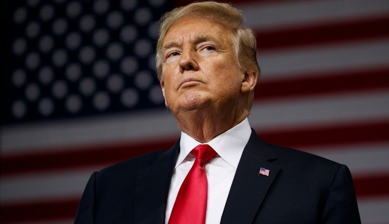 FILE - In this  July 31, 2018, file photo, President Donald Trump pauses during remarks at a campaign rally at Florida State Fairgrounds Expo Hall in Tampa, Fla. The Robesonian paper in Lumberton, N.C., announced itâs dropping an 8-page color comics section from Sunday editions. A newspaper editorial said it cut the comics because of rising newsprint costs spurred by Trump administration tariffs on imported paper. The newspaper says itâs âa decision that we really believe was made at the White House.â