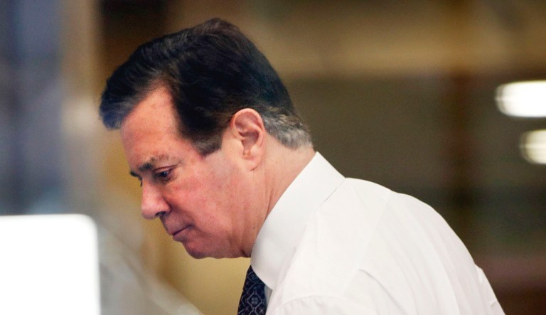 Former Trump campaign chairman Paul Manafort goes through security as he arrives at federal court.