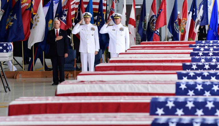 Vice President Mike Pence, left, Commander of U.S. Indo-Pacific Command Adm. Phil Davidson, center, and Rear Adm. Jon Kreitz, deputy director of the POW/MIA Accounting Agency, attend at a ceremony marking the arrival of the remains believed to be of American service members who fell in the Korean War.