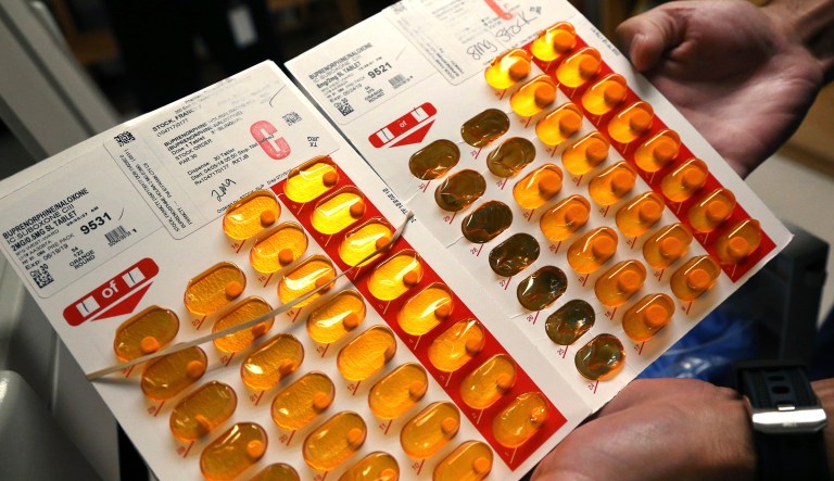 Nurse Brian Toia holds tabs of buprenorphine, a drug which controls heroin and opioid cravings, as he prepares to administer the drug.