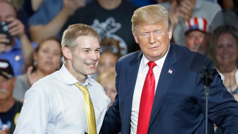 President Trump, right, encourages Rep. Jim Jordan, R-Ohio, left, to speak during a rally.