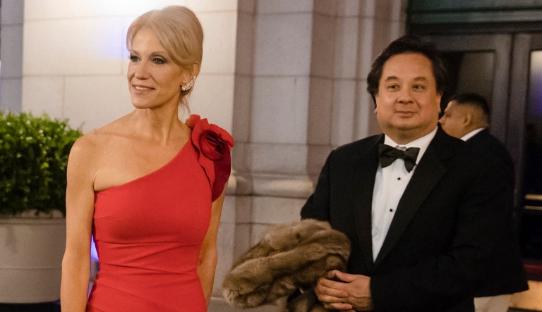 In this Thursday, Jan. 19, 2017 photo, President-elect Donald Trump adviser Kellyanne Conway, center, accompanied by her husband, George, speaks with members of the media as they arrive for a dinner at Union Station in Washington, the day before Trump's inauguration.