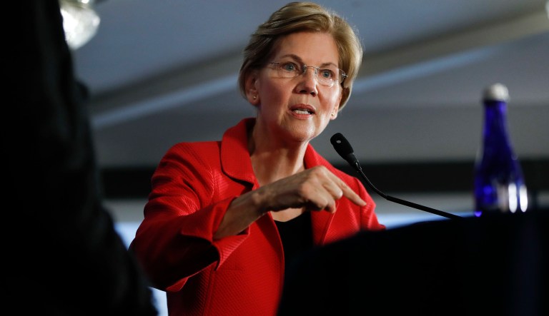 Sen. Elizabeth Warren, D-Mass., gestures while speaking at the National Press Club in Washington, Tuesday, Aug. 21, 2018. Warren wants a lifetime ban on members of Congress from getting hired as lobbyists after they leave public office. She also wants to prohibit lawmakers from owning or trading individual stocks while in office.