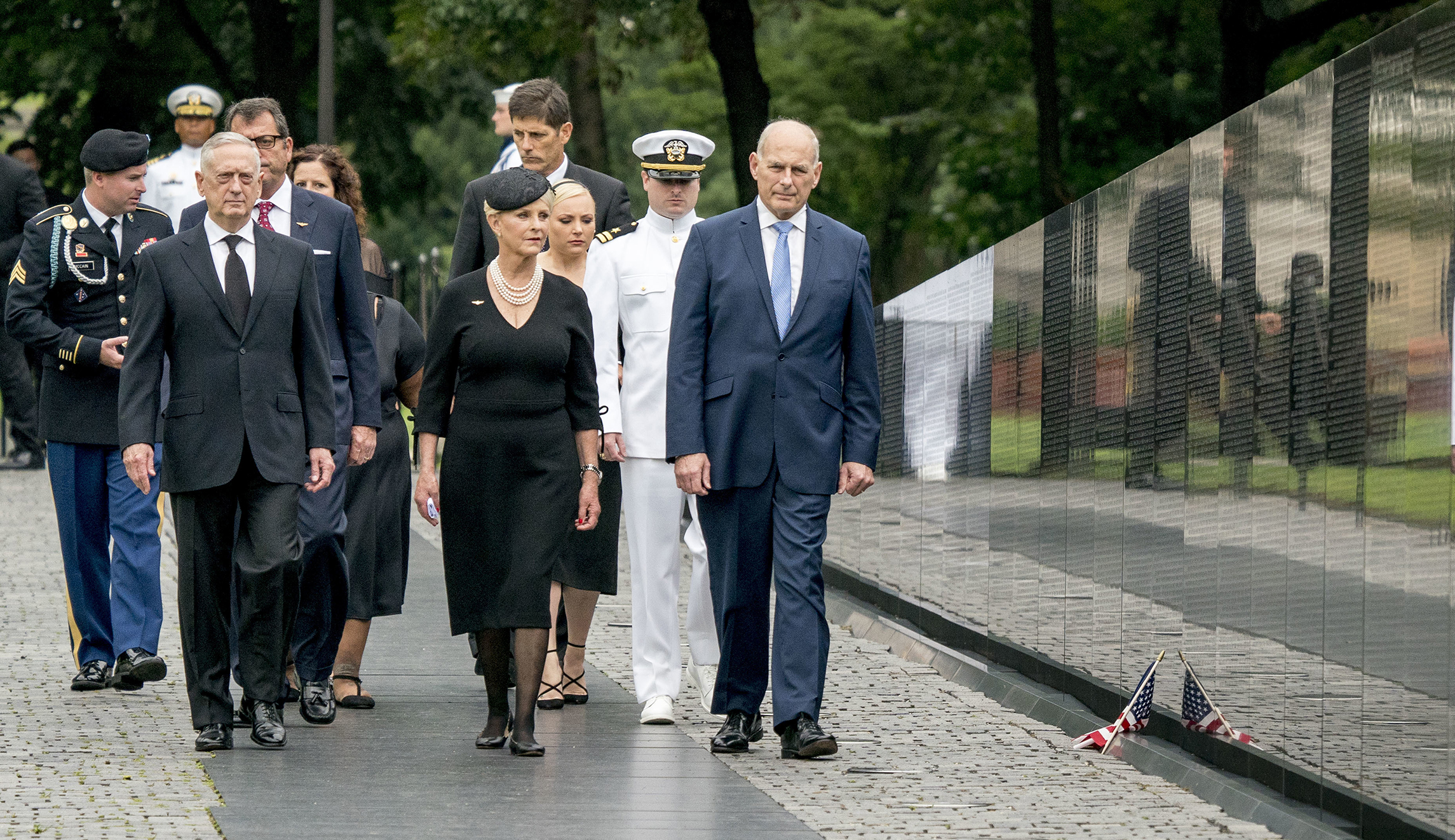 Cindy McCain, wife of, Sen. John McCain, R-Ariz., accompanied by President Trump's Chief of Staff John Kelly, right, Defense Secretary Jim Mattis, left, and family members, arrives at the Vietnam Veterans Memorial in Washington, Saturday, Sept. 1, 2018, during a funeral procession to carry the casket of her husband from the U.S. Capitol to National Cathedral for a Memorial Service. McCain served as a Navy pilot during the Vietnam War and was a prisoner of war for more than five years. 