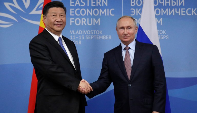 Chinese President Xi Jinping, left, and Russian President Vladimir Putin shake hands during their meeting at the Eastern Economic Forum in Vladivostok, Russia, Tuesday, Sept. 11, 2018.