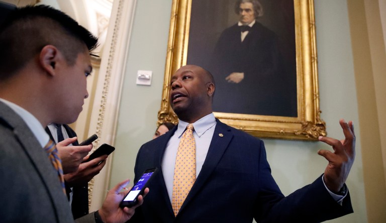Sen. Tim Scott, R-S.C., speaks with a reporter as he arrives for the Republican policy luncheon, on Capitol Hill, Tuesday, Sept. 25, 2018 in Washington.