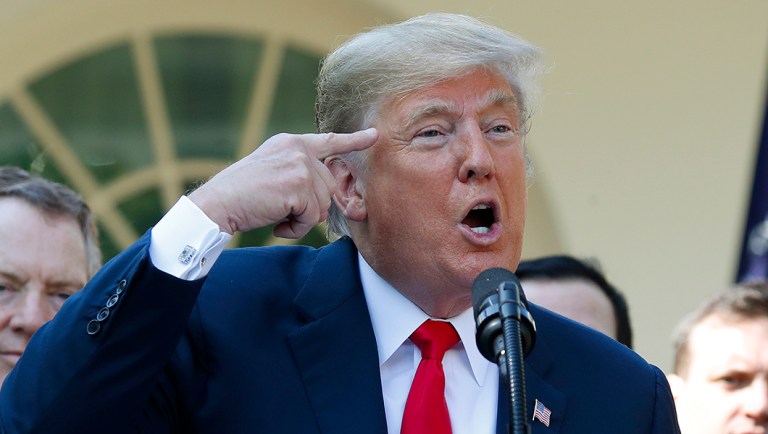 President Trump gestures as he answers questions from members of the media.