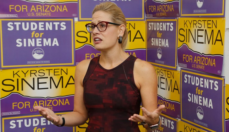 Democratic Rep. Kyrsten Sinema, who is running against Republican Rep. Martha McSally for the open Arizona Senate seat Jeff Flake, R-Ariz., is vacating, talks to campaign volunteers, Tuesday, Oct. 2, 2018, in Tempe, Ariz.