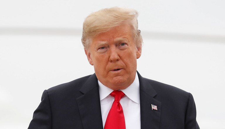 President Trump walks across the tarmac before boarding Air Force One.