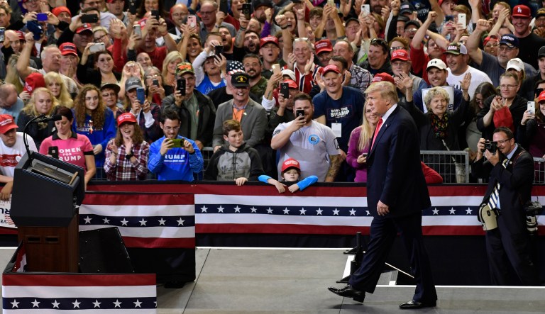 President Donald Trump walks the stage as he speaks at a rally in Council Bluffs, Iowa, Tuesday, Oct. 9, 2018.