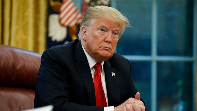 President Trump listens to a question during an interview.