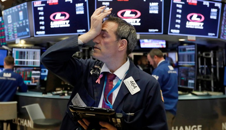 Trader Gregory Rowe works on the floor of the New York Stock Exchange, Tuesday, Oct. 23, 2018. Stocks are opening sharply lower on Wall Street following big drops in Asia and Europe.