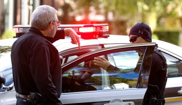 Officers with the Uniform Division of the United States Secret Service talk at a checkpoint near the home of former President Barack Obama, Wednesday, Oct. 24, 2018, in Washington. The U.S. Secret Service says agents have intercepted packages containing "possible explosive devices" addressed to former President Barack Obama and Hillary Clinton.