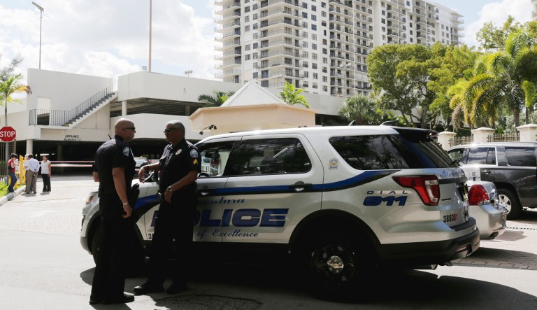 Law enforcement guard the entrance to an apartment building where the last known address was for Cesar Sayoc in Aventura, Fla., on Friday.