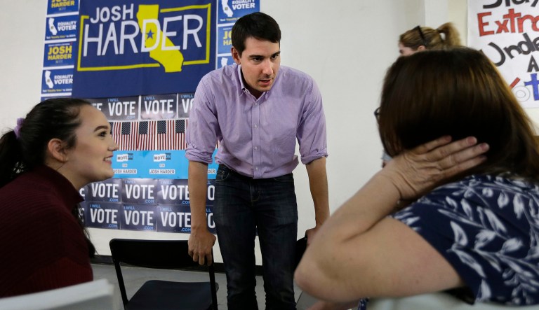 In this photo taken Thursday, Oct. 25, 2018, Josh Harder the Democratic candidate for the California 10th Congressional District, talks with supporters Rebecca, left, and Michelle Tennell, right, in Modesto, Calif. Harder is trying to unseat incumbent Republican Rep. Jeff Denham for the 10th Congressional District seat in the November election.
