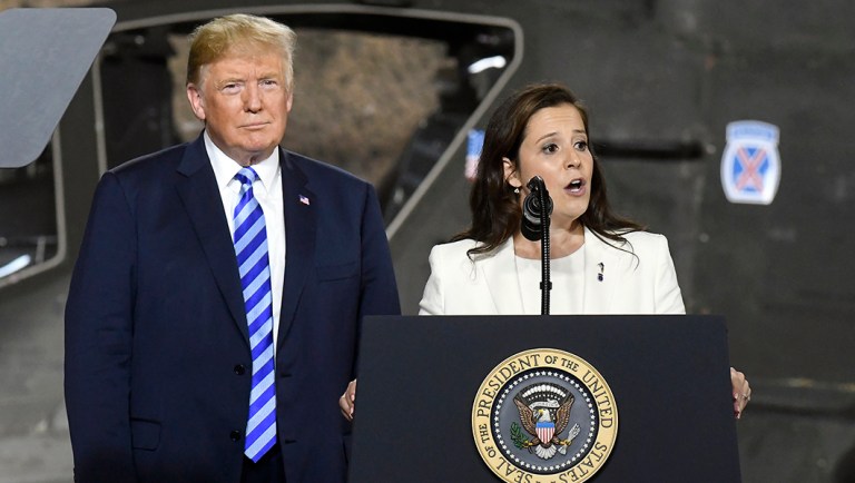 President Trump, left, listens as Rep. Elise Stefanik, R-N.Y., speaks.