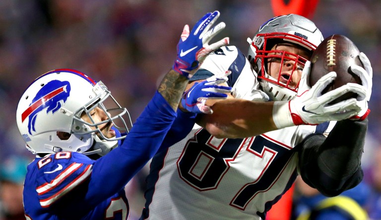 New England Patriots tight end Rob Gronkowski (right) makes a catch against Buffalo Bills defensive back Phillip Gaines during the second half of an NFL football game in Orchard Park, N.Y. 