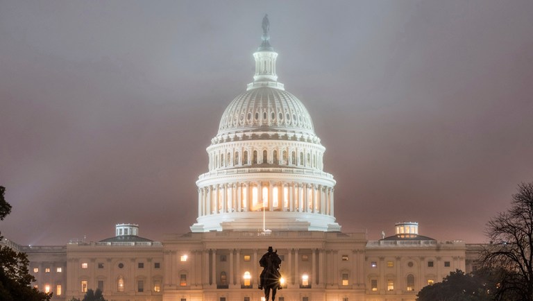 The U.S. Capitol Building in Washington is shrouded in fog early in the morning.