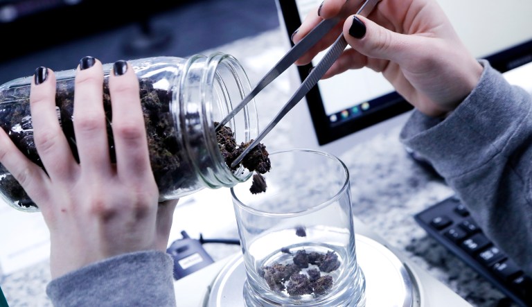 An attendant weighs marijuana at the Far West Holistic Center dispensary, Wednesday, Nov. 7, 2018, in Detroit.