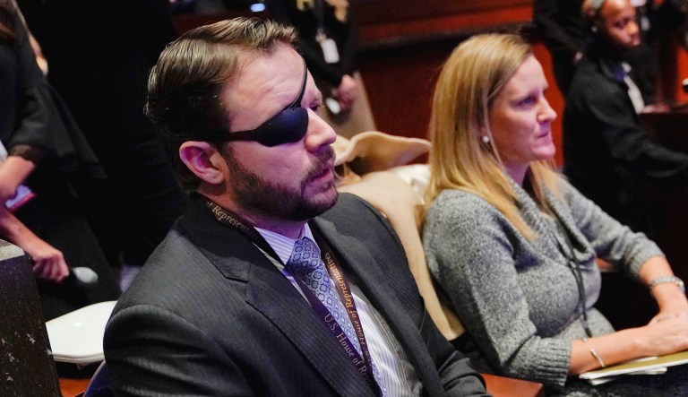 Rep.-elect Dan Crenshaw, R-Texas, left seated, listen during member-elect orientations on Capitol Hill in Washington. 