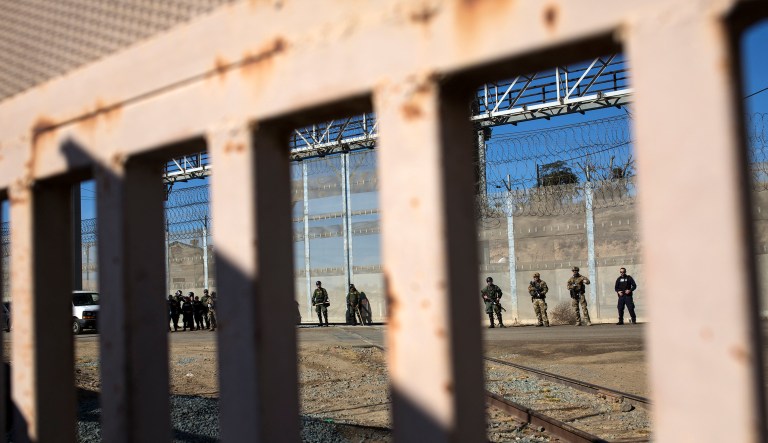 U.S. border agents stand guard at the Mexico-U.S. border after migrants pushed past Mexican police at the Chaparral crossing, seen from Tijuana, Mexico, on Nov. 25, 2018.