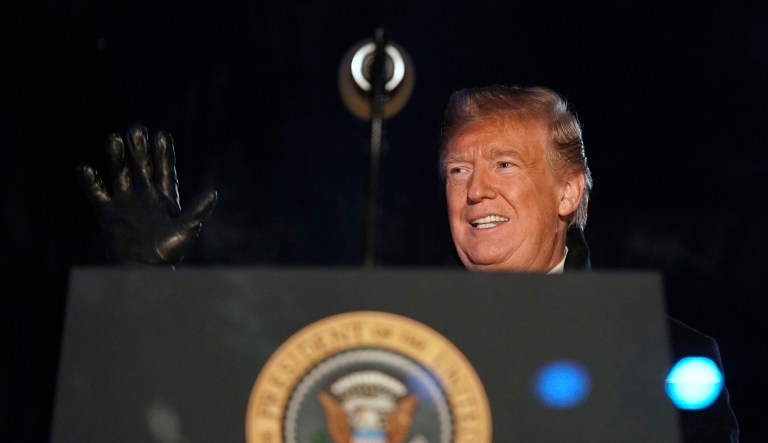 President Trump waves as he and first lady Melania Trump light the National Christmas Tree during a ceremony on the Ellipse near the White House in Washington, Wednesday, Nov. 28, 2018. 