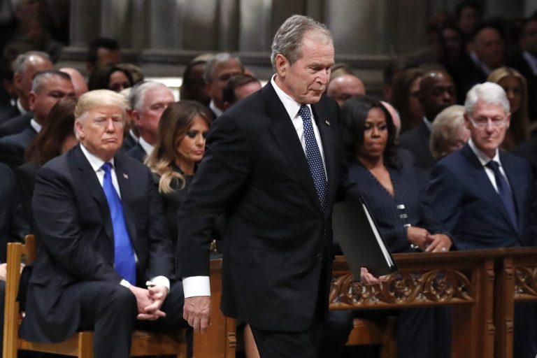 Former President George W. Bush walks past President Trump, first lady Melania Trump, Michelle Obama and former President Bill Clinton to give a eulogy for his father, former President George H.W. Bush during the State Funeral at the National Cathedral, Wednesday, Dec. 5, 2018, in Washington.