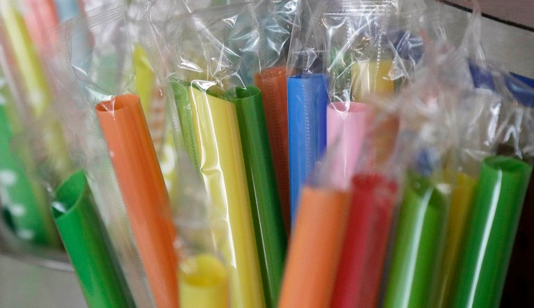 Wrapped plastic straws are seen at a bubble tea shop.