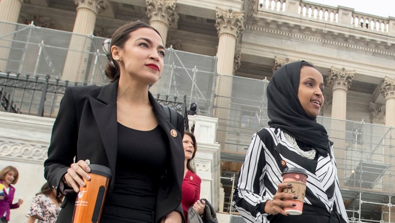 Rep. Alexandria Ocasio-Cortez, D-N.Y., left, and Rep. Ilhan Omar, D-Minn., second from left, walk down the House steps to take a group photograph.