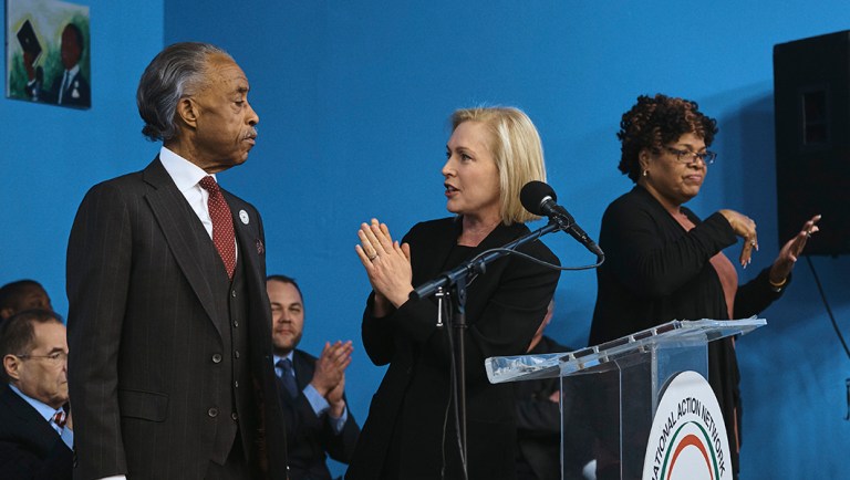 Sen. Kirsten Gillibrand, D-N.Y., center, gestures towards activist Al Sharpton, left, during an event celebrating the life and legacy of Martin Luther King Jr.
