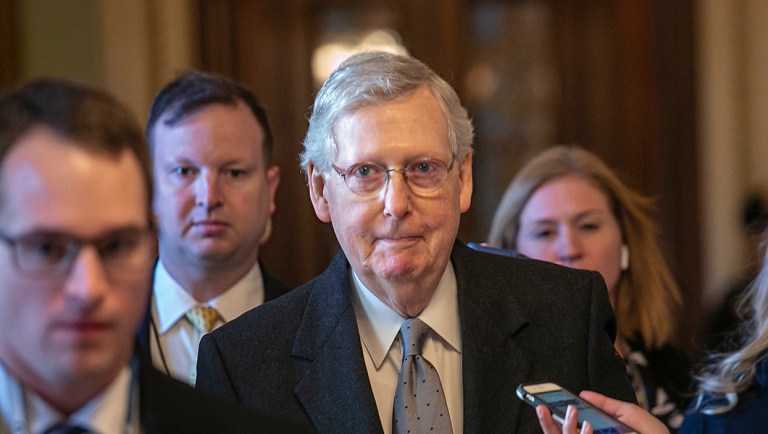 Senate Majority Leader Mitch McConnell, R-Ky., leaves the chamber after speaking about his plan to move a 1,300-page spending measure.