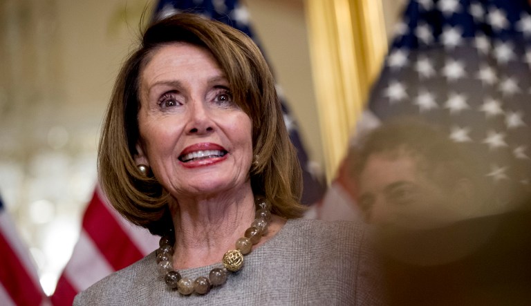 House Speaker Nancy Pelosi of Calif., joined by Democratic House members, smiles as she speaks to members of the media.