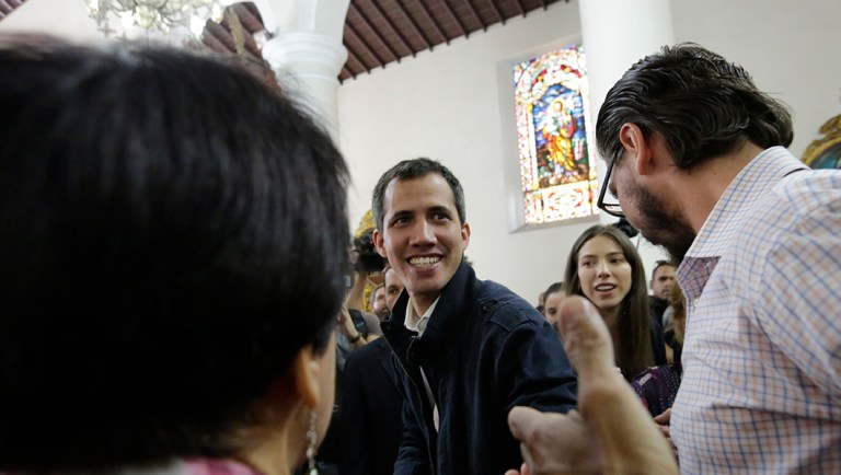 Opposition National Assembly leader Juan Guaido, who declared himself interim president, greets supporters.