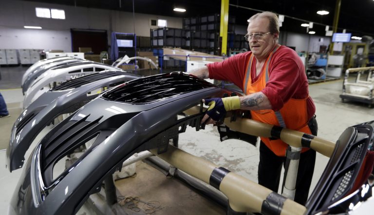 This photo shows Clifford Goff, a bezel assembler, transferring a front end of a General Motors Chevrolet Cruze during assembly at Jamestown Industries, in Youngstown, Ohio on Wednesday, Nov. 28, 2018. 