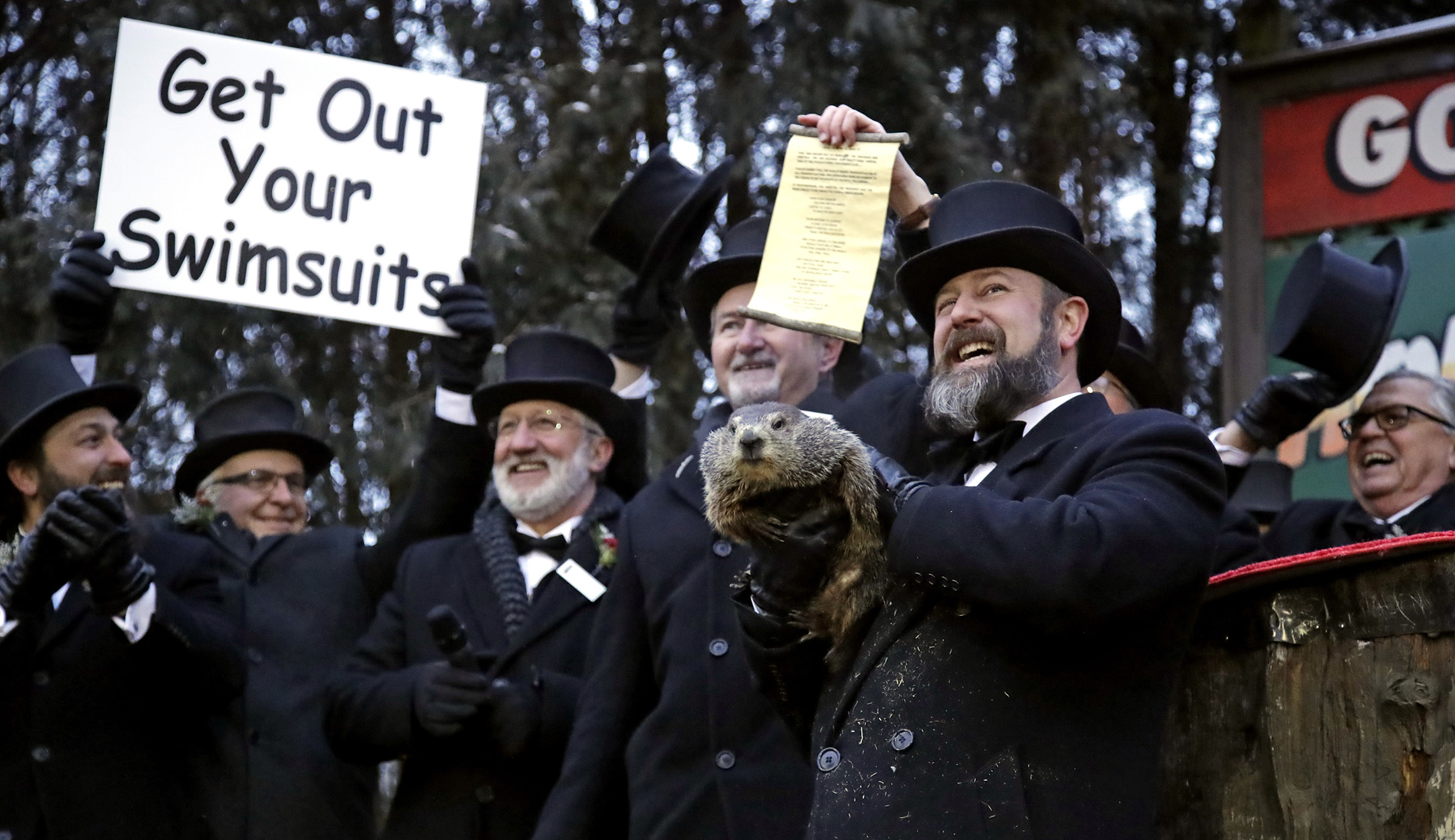 Groundhog Club co-handler Al Dereume, second from right, holds Punxsutawney Phil, the weather prognosticating groundhog, during the 133rd celebration of Groundhog Day on Gobbler's Knob in Punxsutawney, Pa., on Saturday.