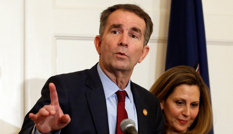 Virginia Gov. Ralph Northam, left, gestures as his wife, Pam, listens during a news conference in the Governors Mansion at the Capitol in Richmond, Va., on Saturday.