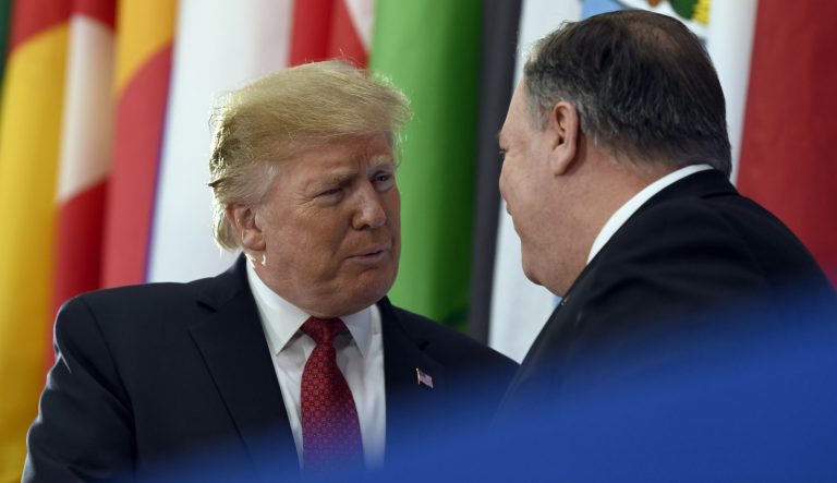 President Donald Trump, left, talks with Secretary of State Mike Pompeo, right, before speaking at the Global Coalition to Defeat ISIS meeting at the State Department in Washington, Wednesday, Feb. 6, 2019. 