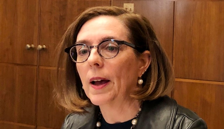 Oregon Gov. Kate Brown speaks to reporters.