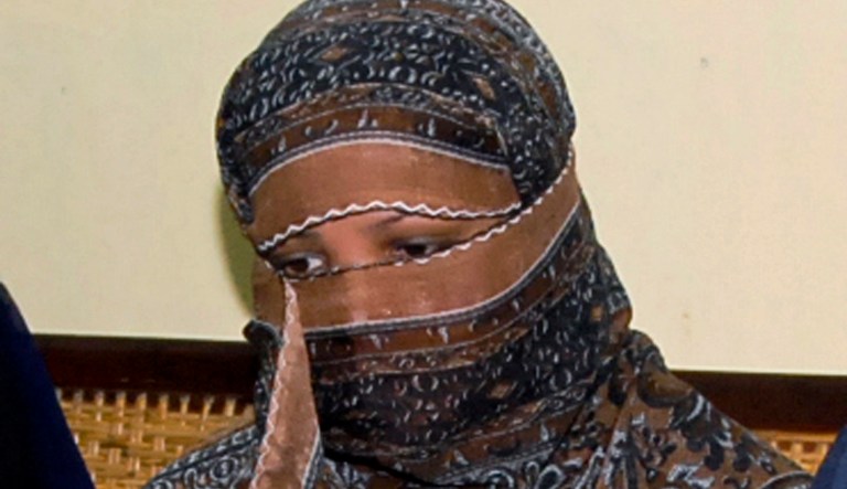 In this Nov. 20, 2010 photo, Asia Bibi, a Pakistani Christian woman, listens to officials at a prison in Sheikhupura near Lahore, Pakistan. 