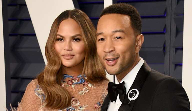 Chrissy Teigen, left, and John Legend arrive at the Vanity Fair Oscar Party on Sunday.