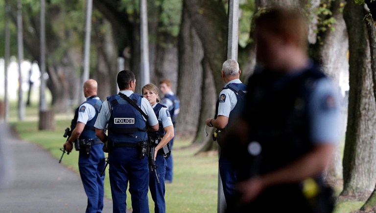 Police keep watch at a park across the road from a a mosque in central Christchurch, New Zealand.