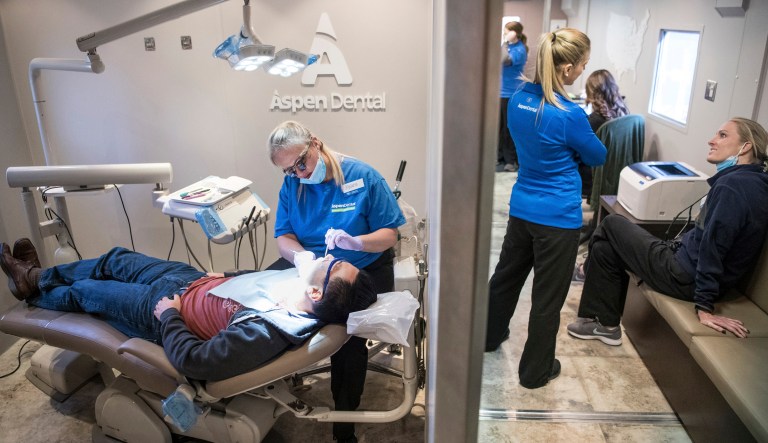 Dental hygienist Melanie Kraemer, left, examines a patient on the Aspen Dental MouthMobile Tuesday March 19, 2019 in Greenville, South Carolina.