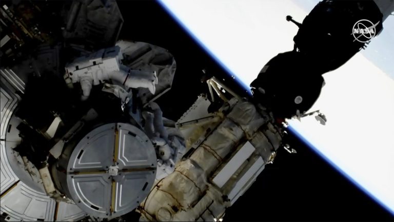 This image provided by NASA shows astronauts Anne McClain and Nick Hague taking a spacewalk to replace aging batteries on the International Space Station.