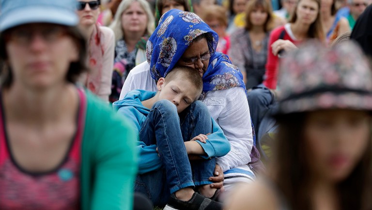 A woman embraces a boy at the "March for Love" following last week's mosque attacks.