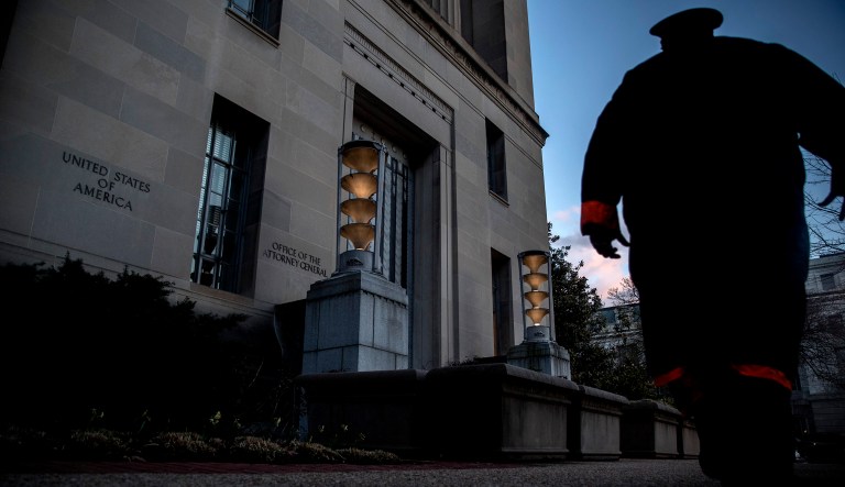 A security officer walks past the Department of Justice in D.C.