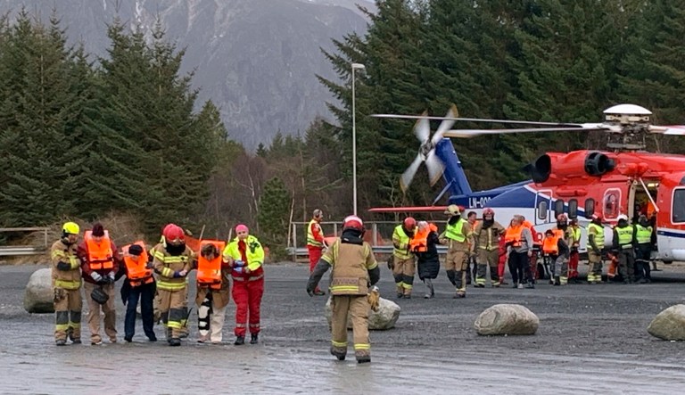 Passengers rescued from the Viking Sky cruise ship are helped from a helicopter in Hustadvika, Norway.