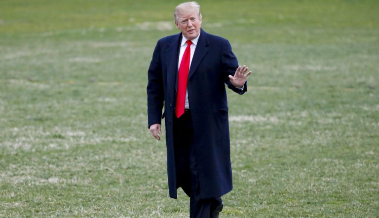President Donald Trump gestures while walking across the South Lawn of the White House in Washington after stepping off Marine One helicopter, Sunday, March 24, 2019, in Washington. 